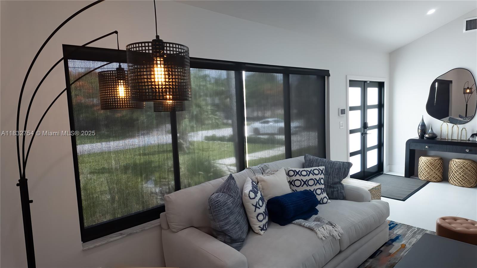 1240 Northeast 27th Terrace Pompano Beach, FL 33062 - Photo 50 of 98 a living room with furniture and a floor to ceiling window