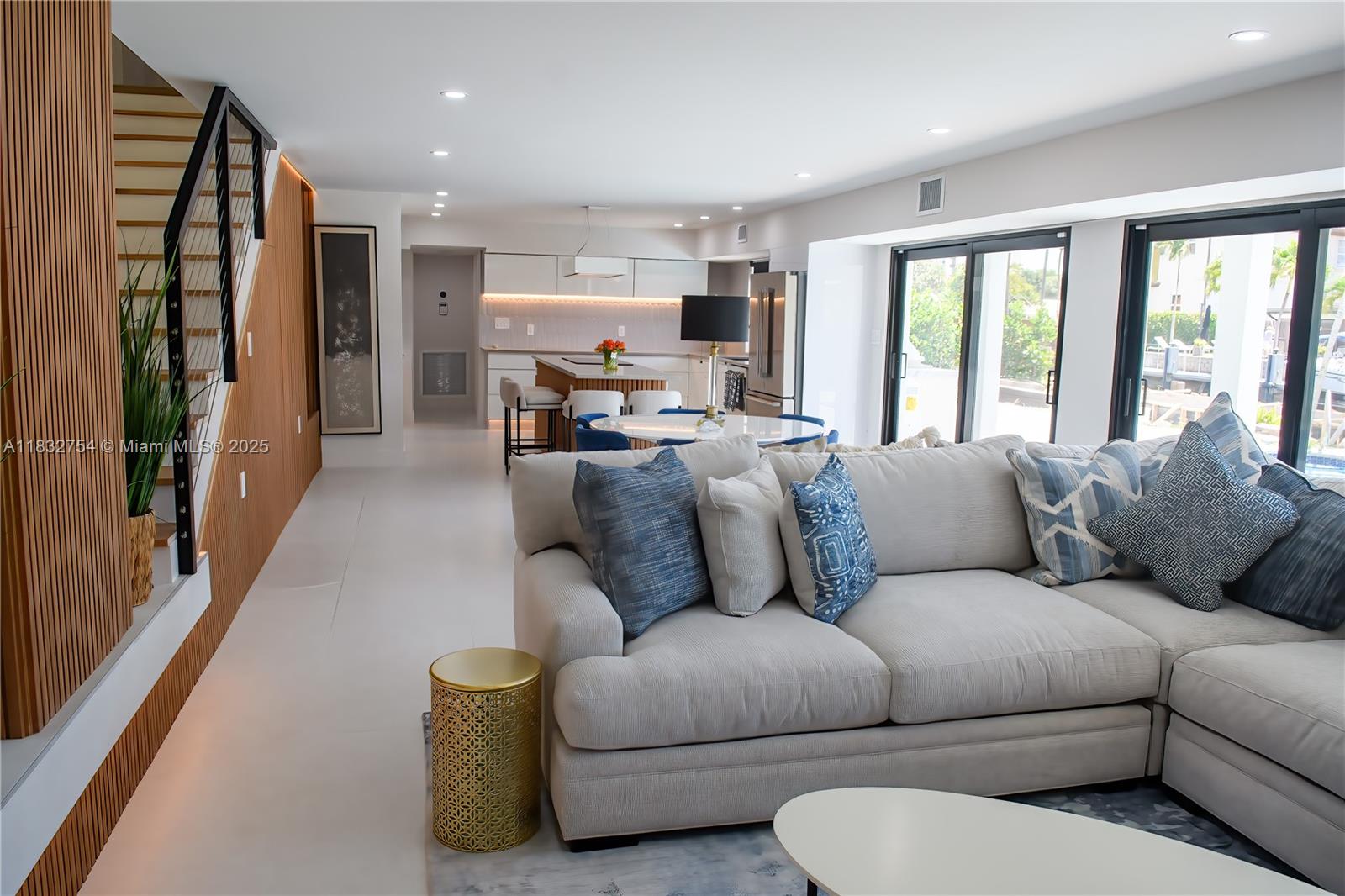 1240 Northeast 27th Terrace Pompano Beach, FL 33062 - Photo 5 of 98 a living room with furniture flat screen tv and large window