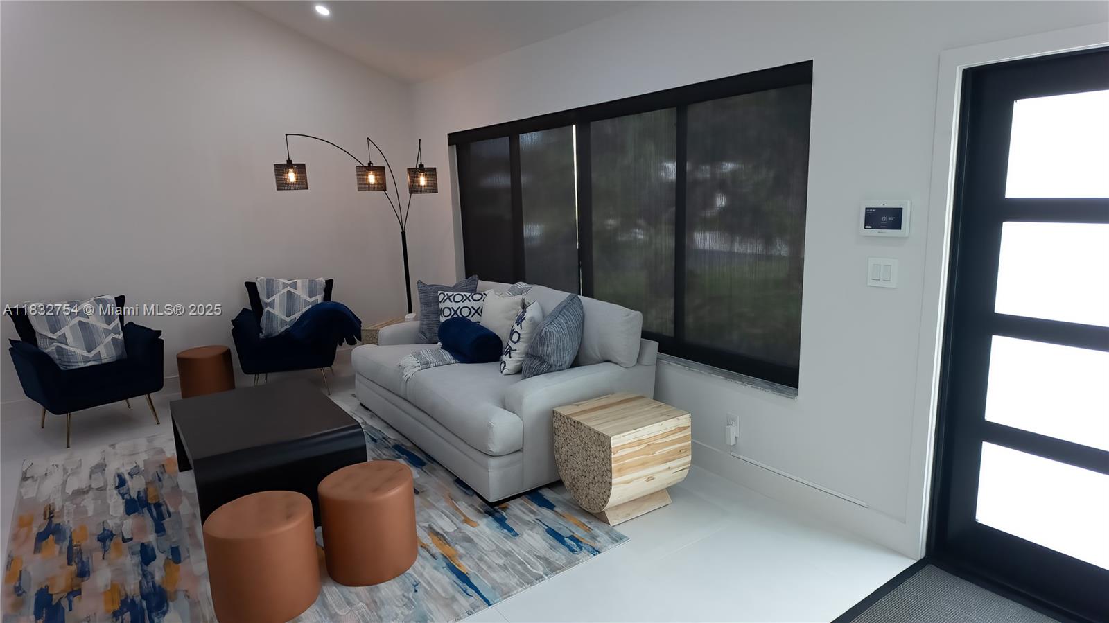 1240 Northeast 27th Terrace Pompano Beach, FL 33062 - Photo 53 of 98 a living room with furniture and a floor to ceiling window