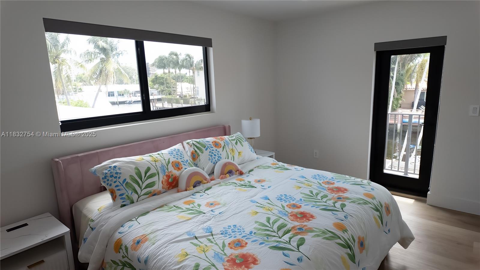 1240 Northeast 27th Terrace Pompano Beach, FL 33062 - Photo 63 of 98 a bedroom with a bed and a large window