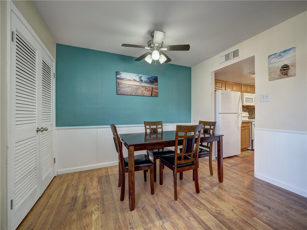 14300 Aloha Street, Unit 151 Corpus Christi, TX 78418 - Photo 11 of 33 a view of a dining room with furniture and wooden floor
