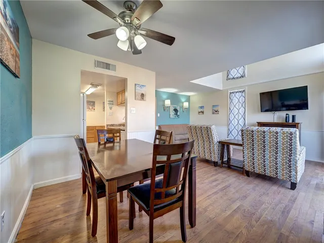 a kitchen with stainless steel appliances granite countertop a sink refrigerator and cabinets