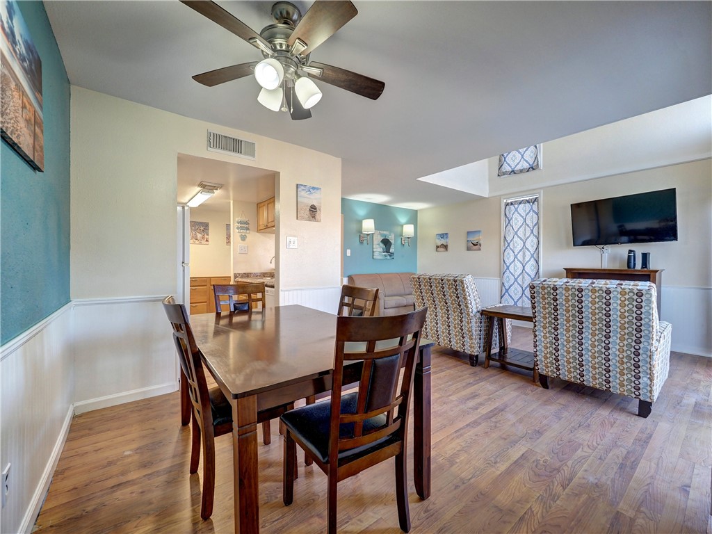 14300 Aloha Street, Unit 151 Corpus Christi, TX 78418 - Photo 12 of 33 a view of a dining room with furniture and wooden floor