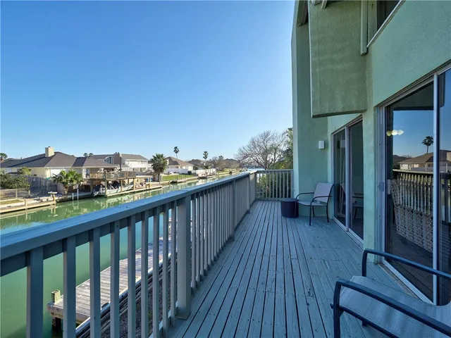 a view of a house with wooden fence