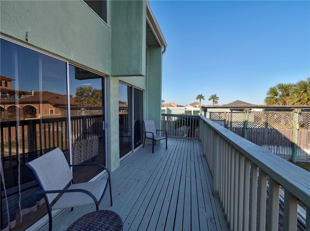 14300 Aloha Street, Unit 151 Corpus Christi, TX 78418 - Photo 19 of 33 a balcony with wooden floor outdoor seating and kitchen view