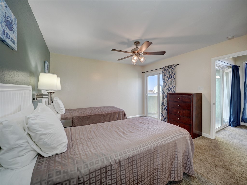 14300 Aloha Street, Unit 151 Corpus Christi, TX 78418 - Photo 27 of 33 a bedroom with a bed and a chandelier