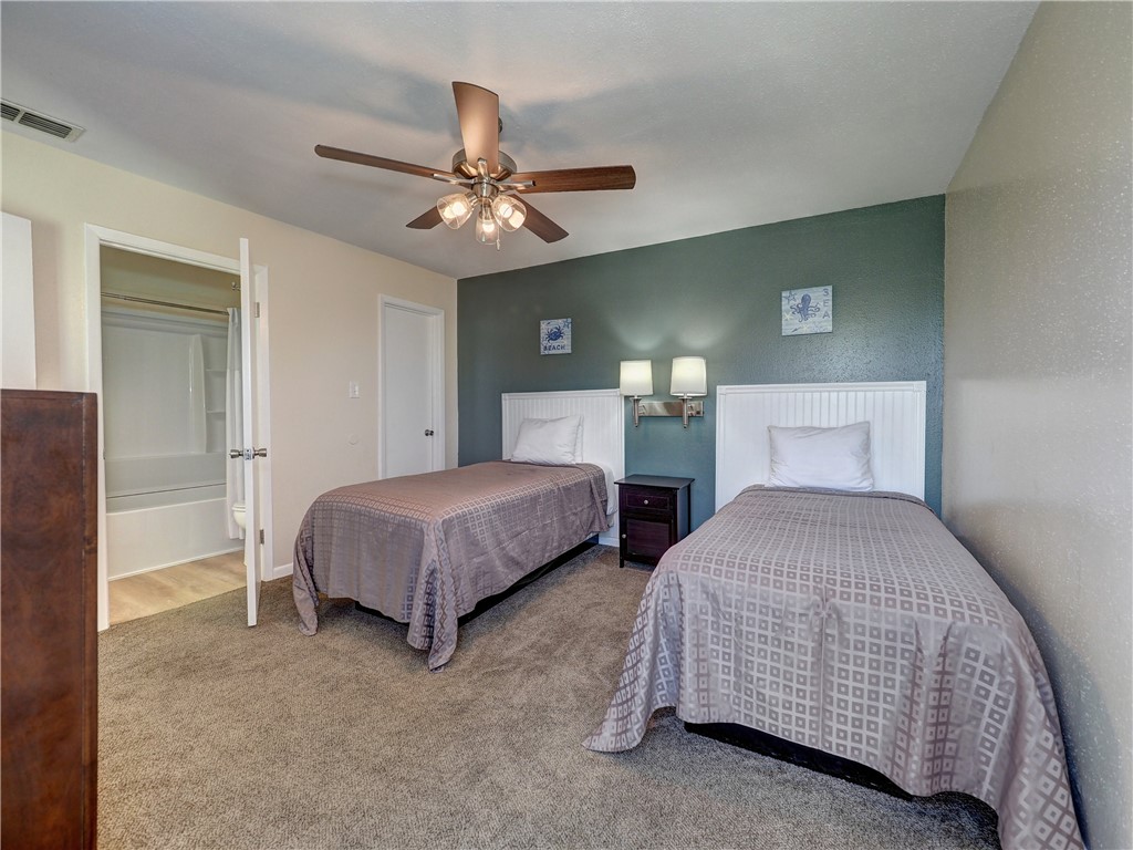 14300 Aloha Street, Unit 151 Corpus Christi, TX 78418 - Photo 28 of 33 a bedroom with bed and a chandelier