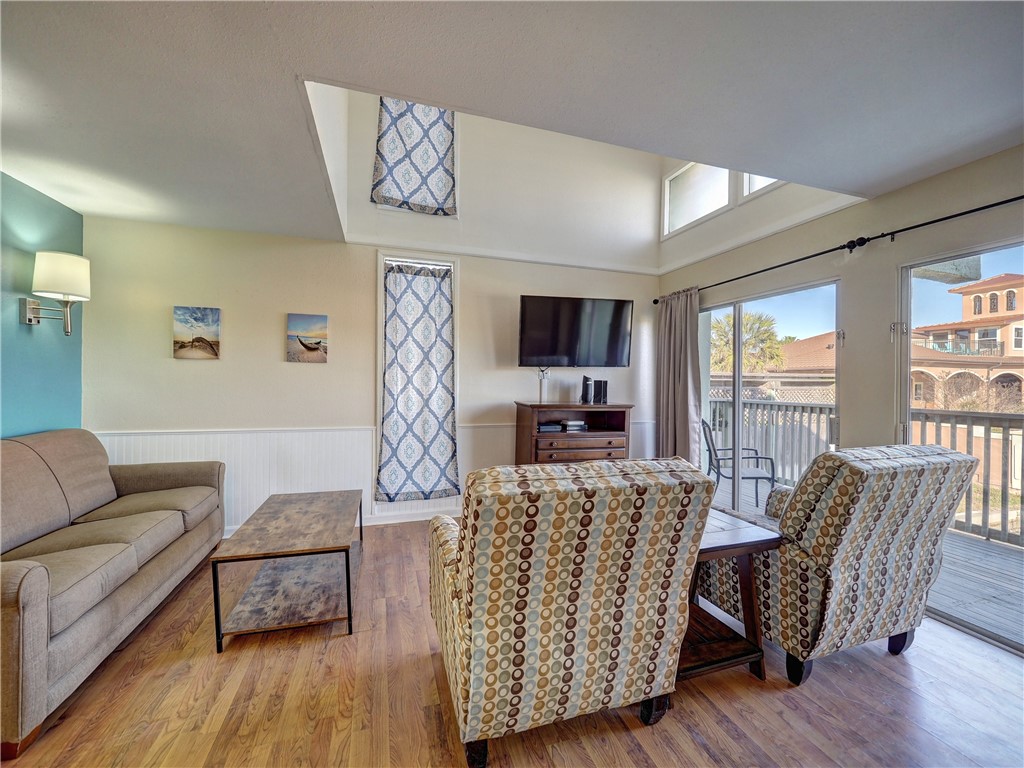 14300 Aloha Street, Unit 151 Corpus Christi, TX 78418 - Photo 8 of 33 a living room with furniture a flat screen tv and a large window