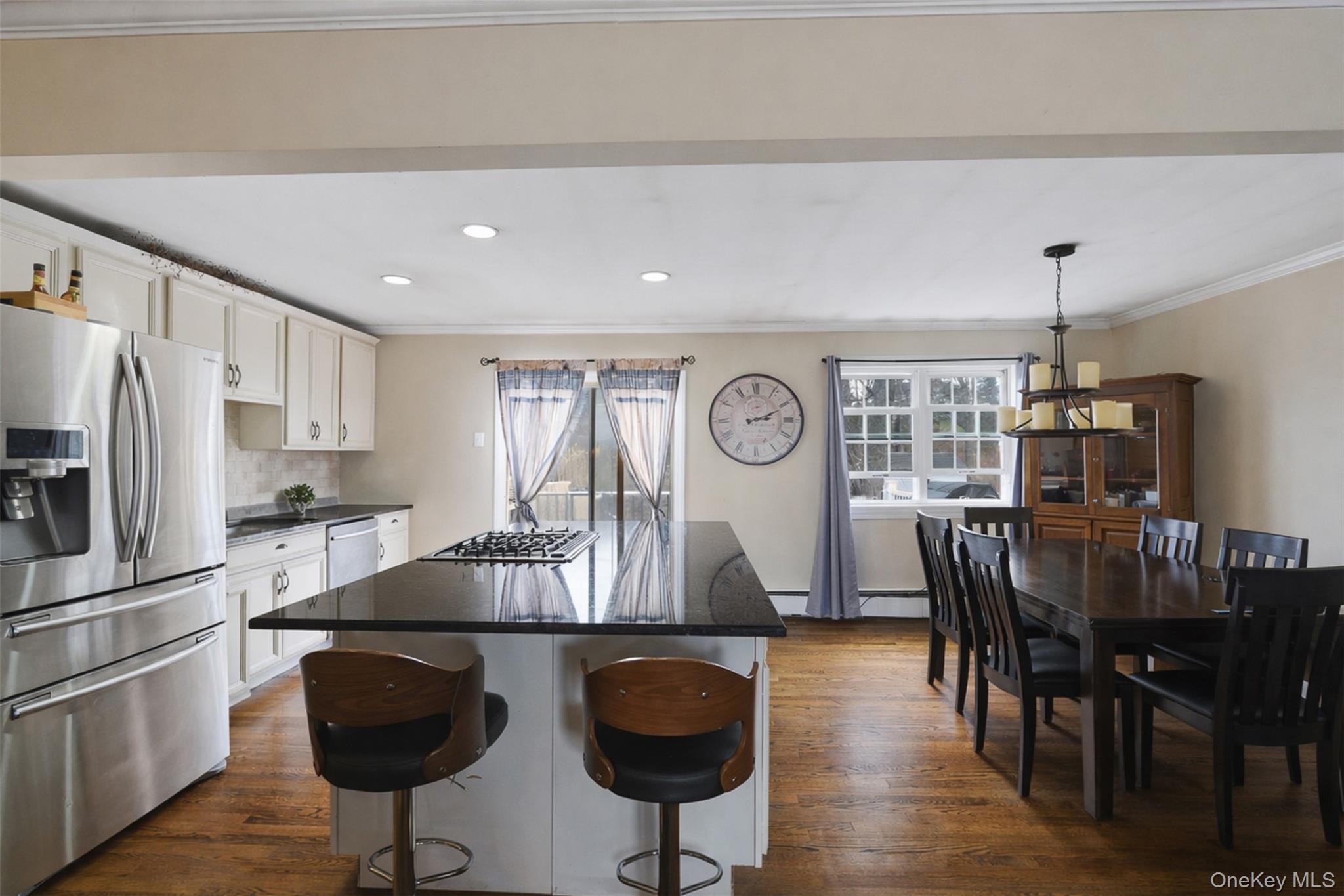 67 High Ridge Road Monroe, NY 10950 - Photo 11 of 34 a kitchen with stainless steel appliances granite countertop a dining table chairs refrigerator and sink