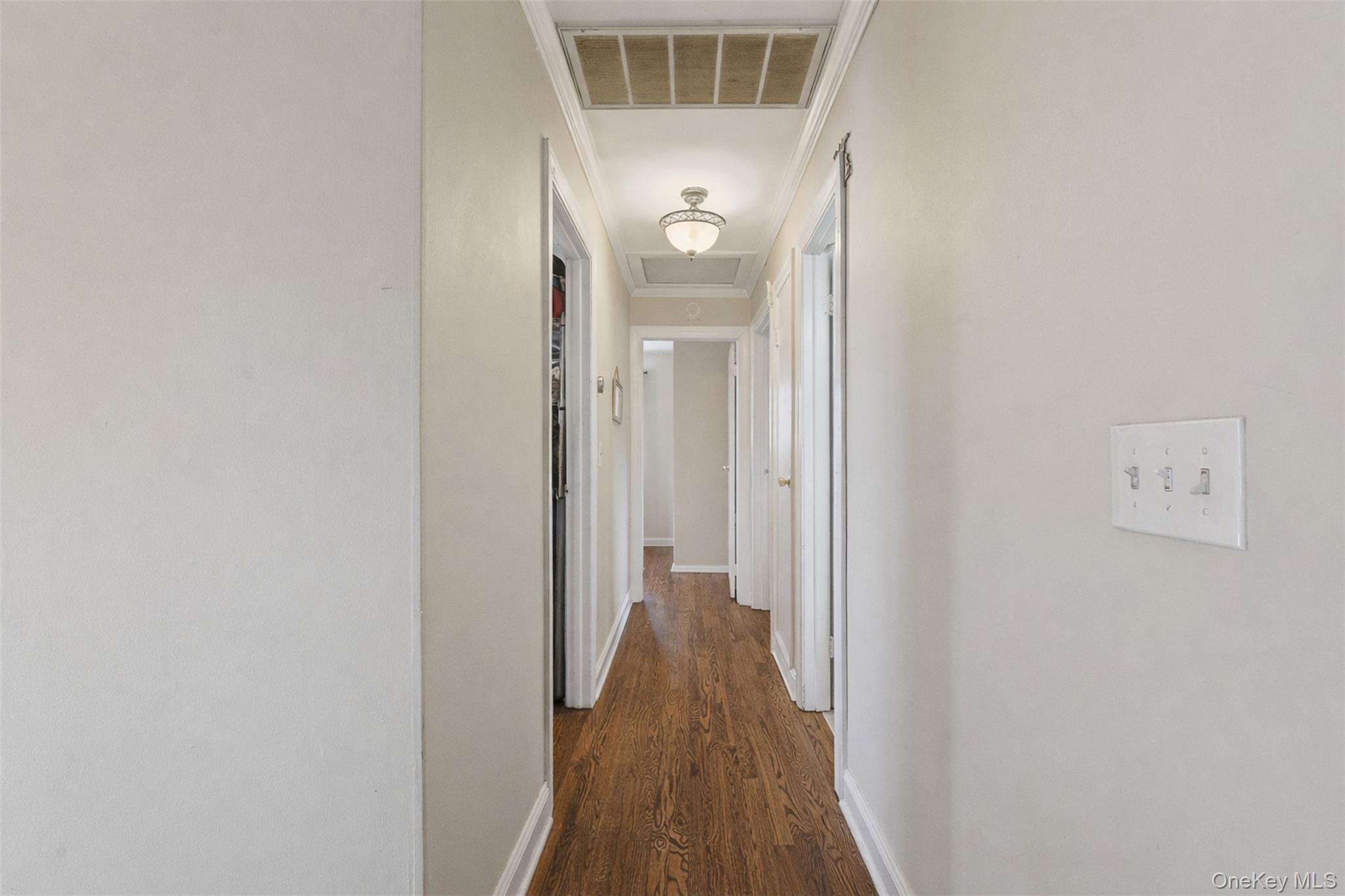 67 High Ridge Road Monroe, NY 10950 - Photo 12 of 34 a view of a hallway with wooden floor and a bathroom