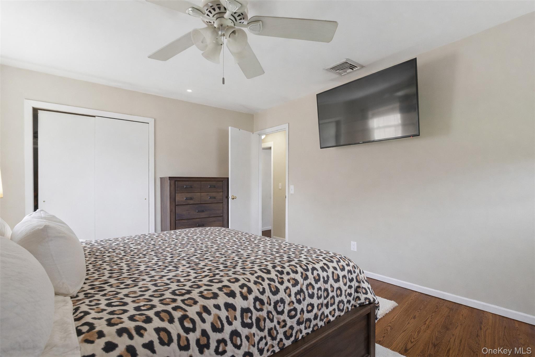 67 High Ridge Road Monroe, NY 10950 - Photo 16 of 34 a bedroom with a bed and a chandelier