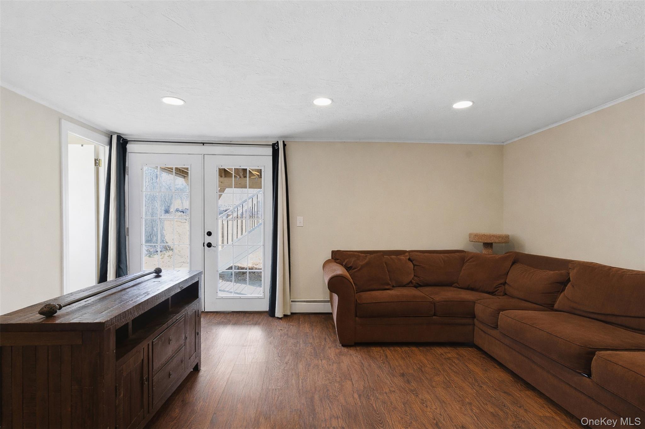 67 High Ridge Road Monroe, NY 10950 - Photo 21 of 34 a living room with furniture and a wooden floor
