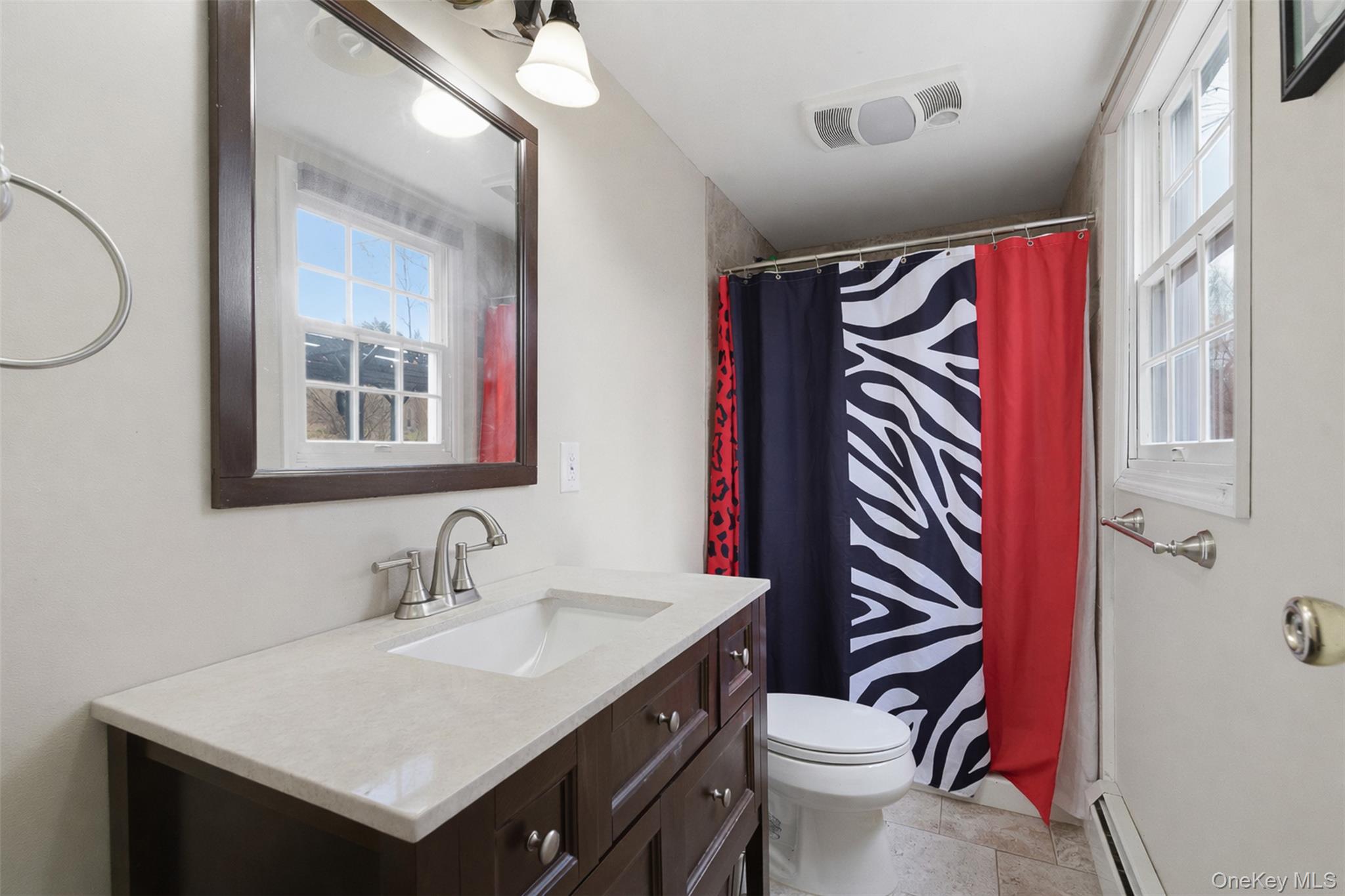 67 High Ridge Road Monroe, NY 10950 - Photo 30 of 34 a bathroom with a sink a toilet and a mirror