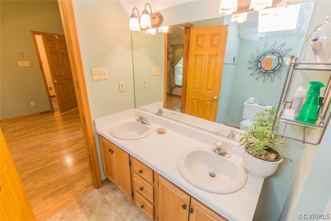 6202 Husting Road Chesterfield, VA 23832 - Photo 35 of 50 a bathroom with a double vanity sink and a mirror