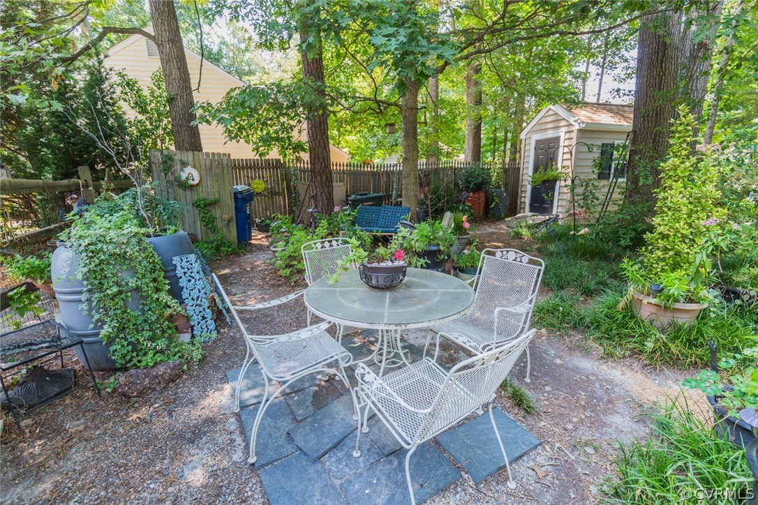 6202 Husting Road Chesterfield, VA 23832 - Photo 39 of 50 a view of a patio with table and chairs potted plants and large tree