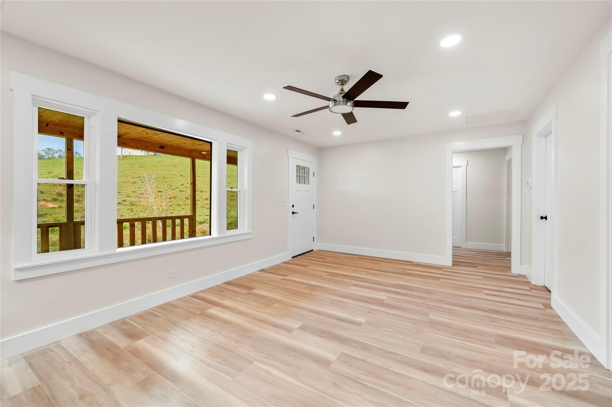 421 Hazel Brook Road Marshall, NC 28753 - Photo 11 of 30 a view of an empty room with a window and a kitchen