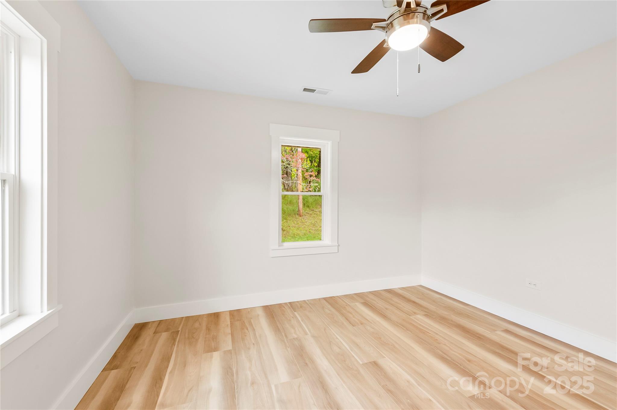 421 Hazel Brook Road Marshall, NC 28753 - Photo 18 of 30 a view of empty room with wooden floor and fan