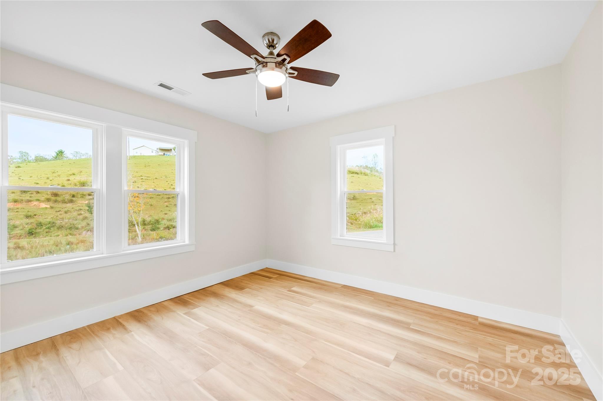 421 Hazel Brook Road Marshall, NC 28753 - Photo 23 of 30 a view of a big room with wooden floor and a window