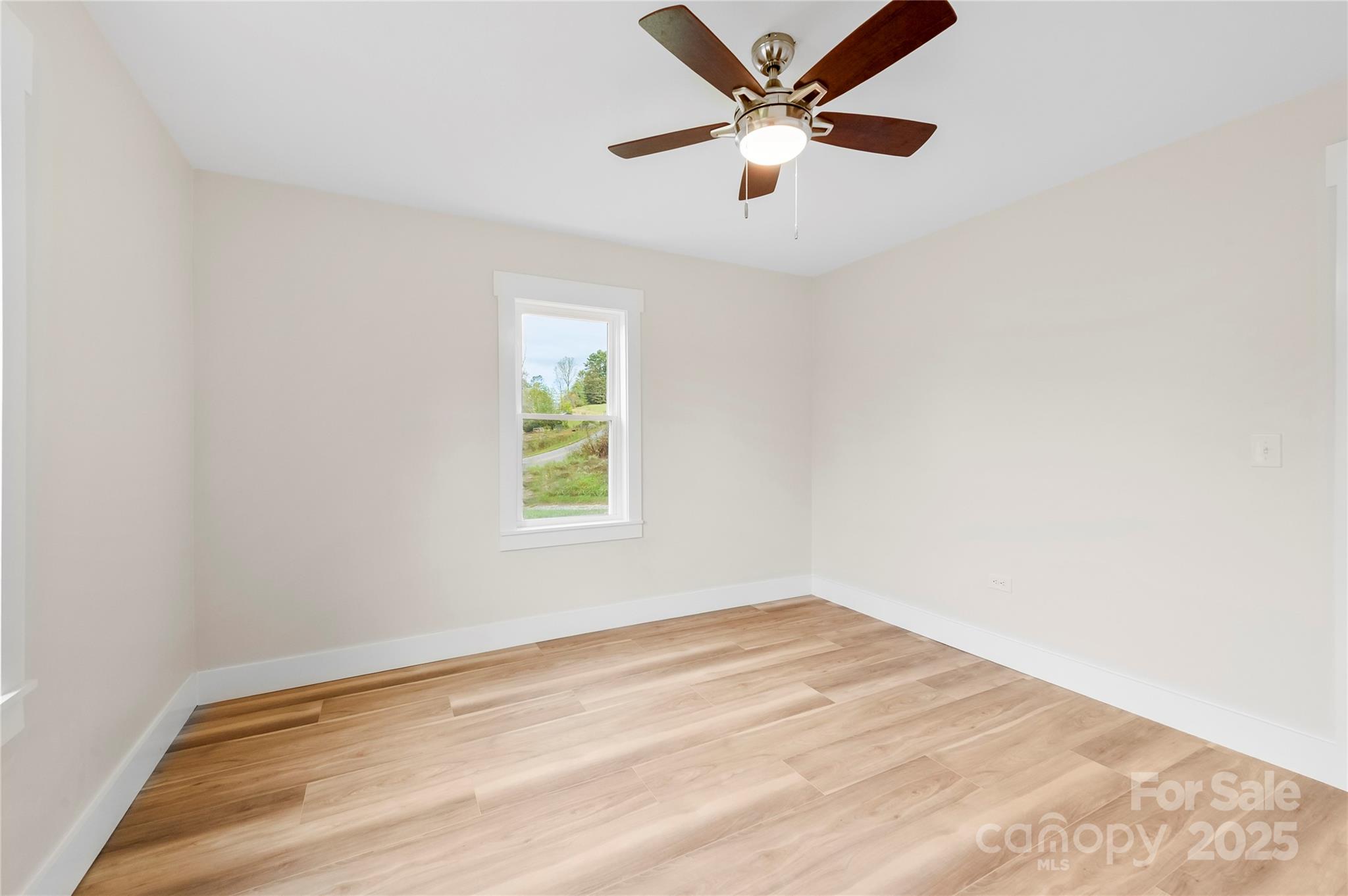 421 Hazel Brook Road Marshall, NC 28753 - Photo 24 of 30 an empty room with a window and a fan