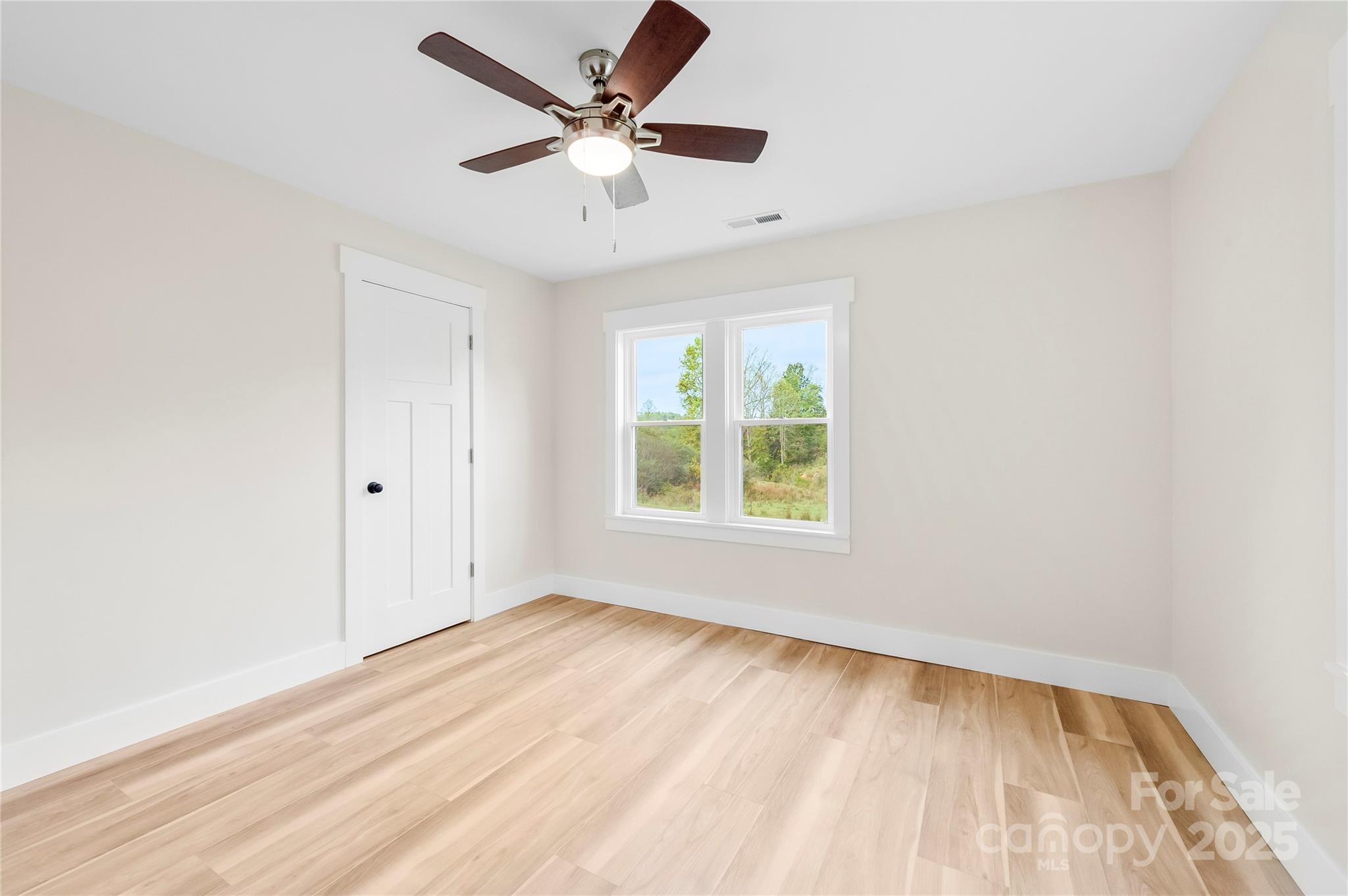 421 Hazel Brook Road Marshall, NC 28753 - Photo 25 of 30 an empty room with a window and a ceiling fan