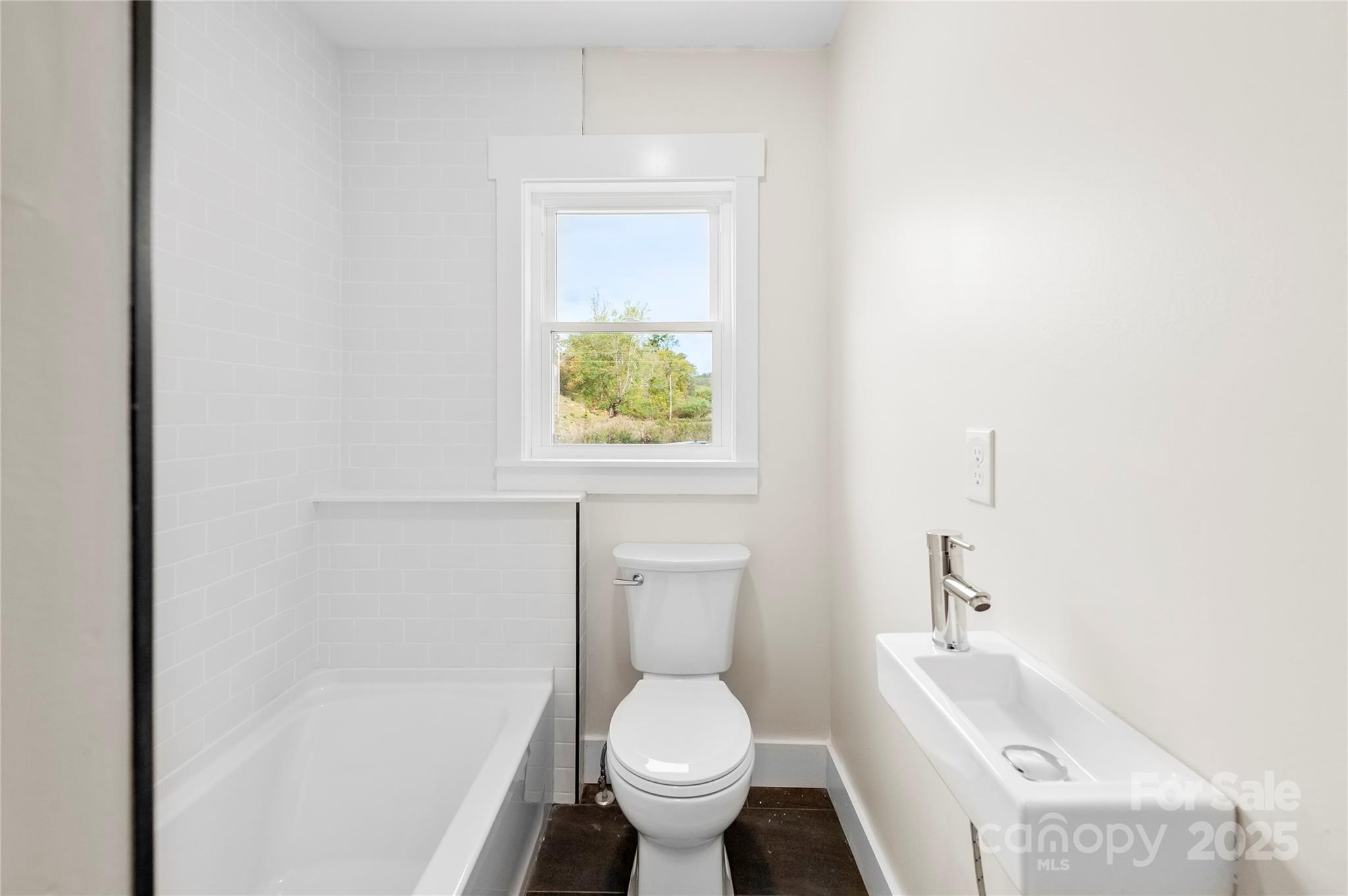 421 Hazel Brook Road Marshall, NC 28753 - Photo 26 of 30 a white toilet sitting next to a bathroom sink and tub