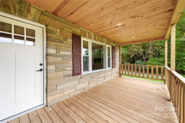 a view of a balcony with wooden floor