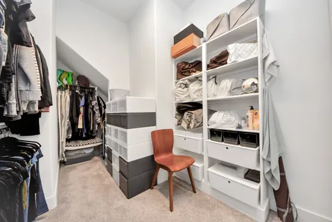 a bedroom with a bed and a chair