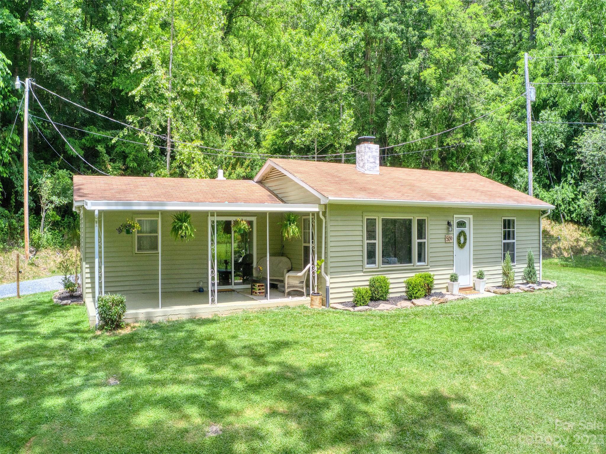 509 Max Thompson Road Canton, NC 28716 - Photo 1 of 34 a view of a house with backyard porch and sitting area
