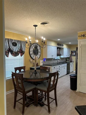 a kitchen with a dining table and chairs