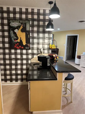 a kitchen with a stove a refrigerator and a dining table