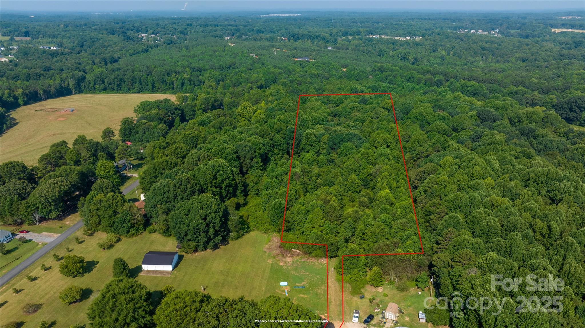 567 Shinnville Road Mooresville, NC 28115 - Photo 4 of 12 an aerial view of residential houses with outdoor space and trees