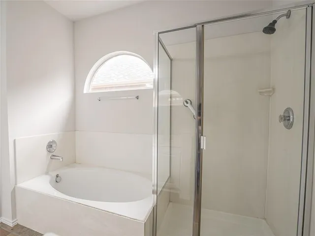 a bathroom with a bathtub and a shower
