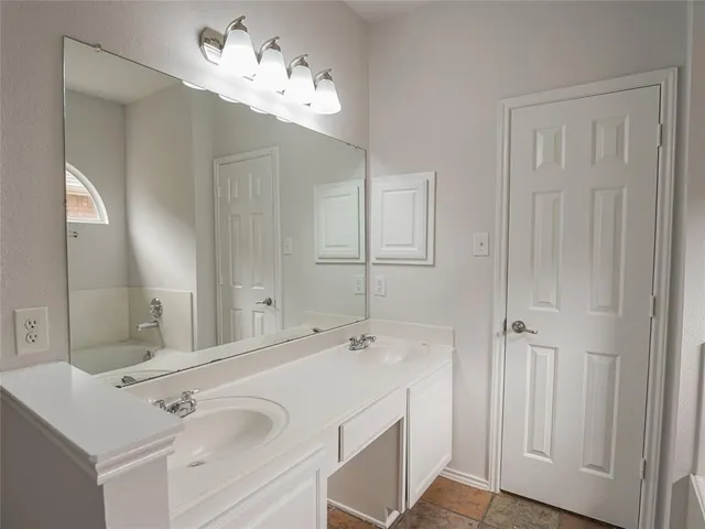 a bathroom with a sink vanity and a mirror