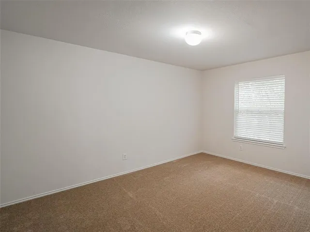 an empty room with a empty space and windows