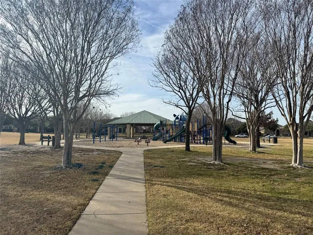 a front view of a building and trees