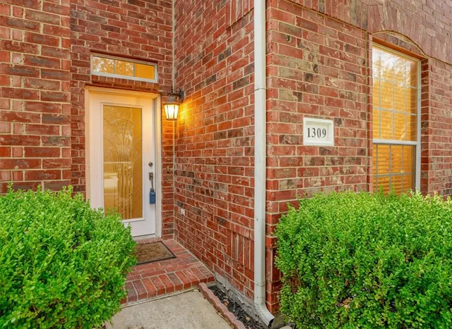 a view of staircase with wooden floor and a chandelier