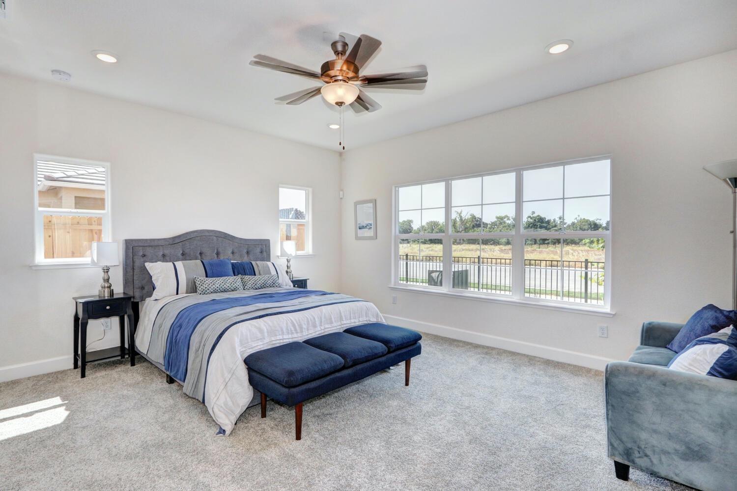 932 Norman Road Galt, CA 95632 - Photo 15 of 21 a spacious bedroom with a bed and a chandelier