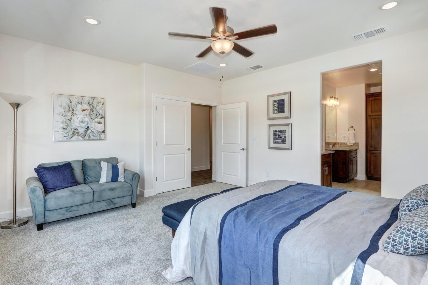 932 Norman Road Galt, CA 95632 - Photo 16 of 21 a spacious bedroom with a bed and a couch
