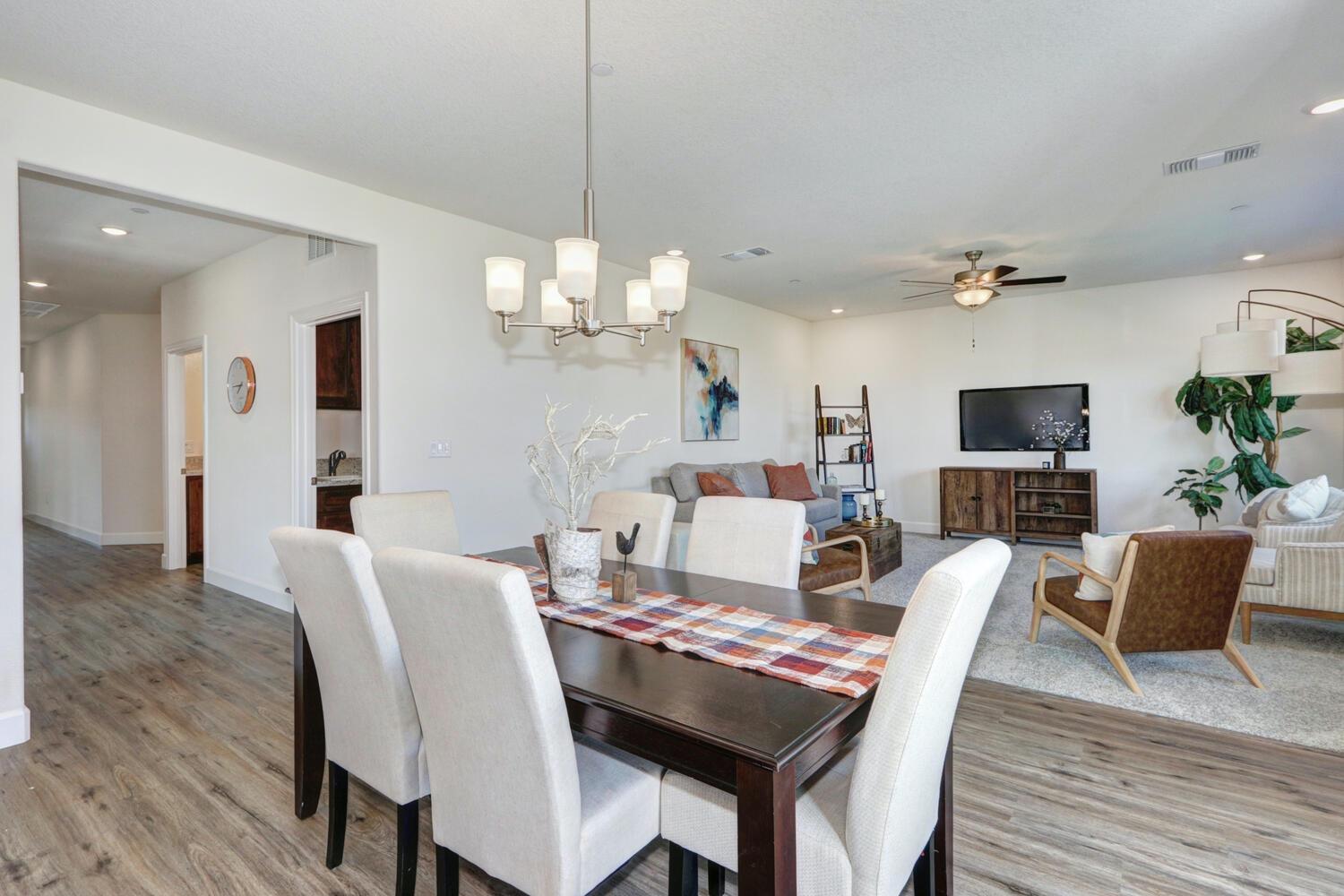 932 Norman Road Galt, CA 95632 - Photo 9 of 21 a view of a dining room with furniture wooden floor and chandelier