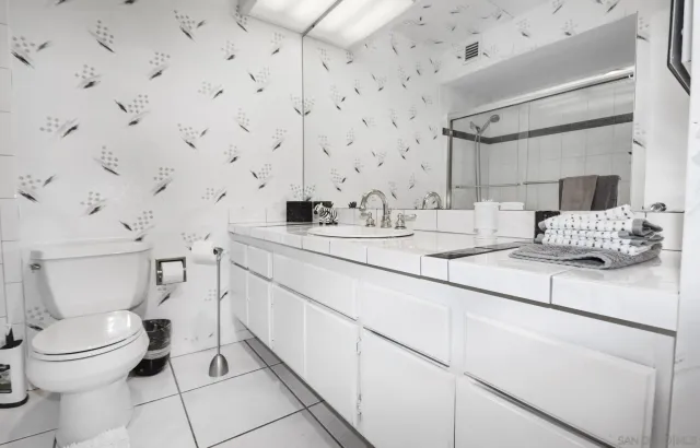 a bathroom with a sink toilet and mirror