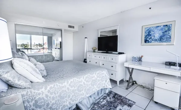 a bedroom with a bed and a flat screen tv