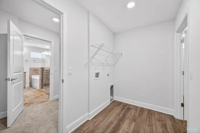 a bathroom with a granite countertop double vanity sink and mirror with bathtub