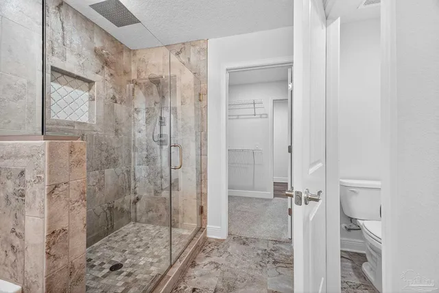 a view of an empty room with glass door and windows