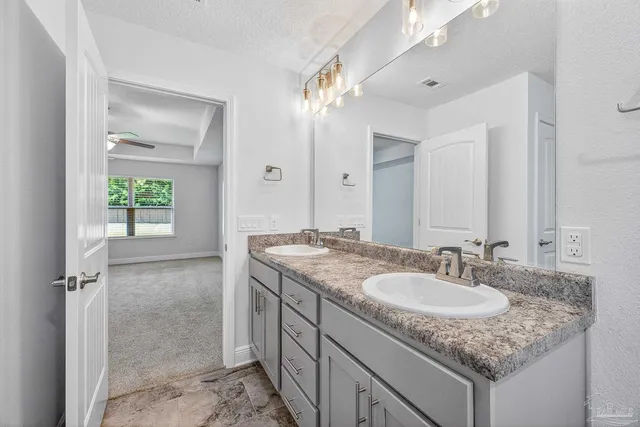 a view of kitchen and an empty room with wooden floor