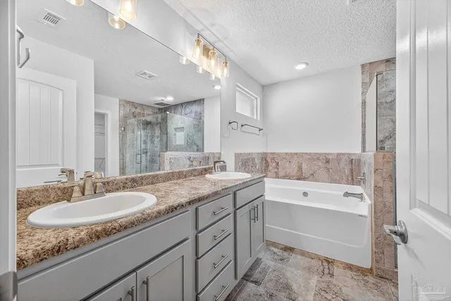 a kitchen with stainless steel appliances kitchen island granite countertop a wooden floors and white cabinets
