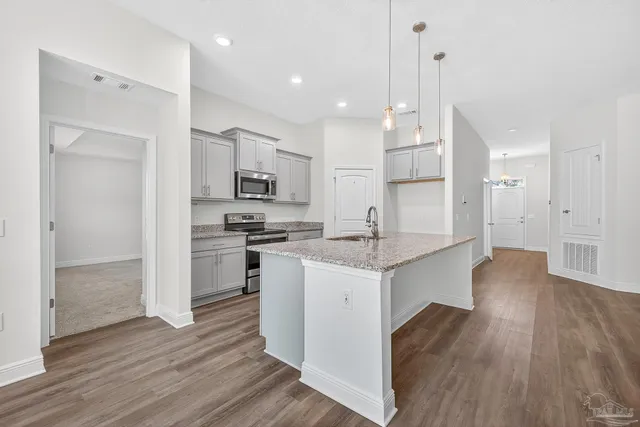 a view of a kitchen with wooden floor and a kitchen