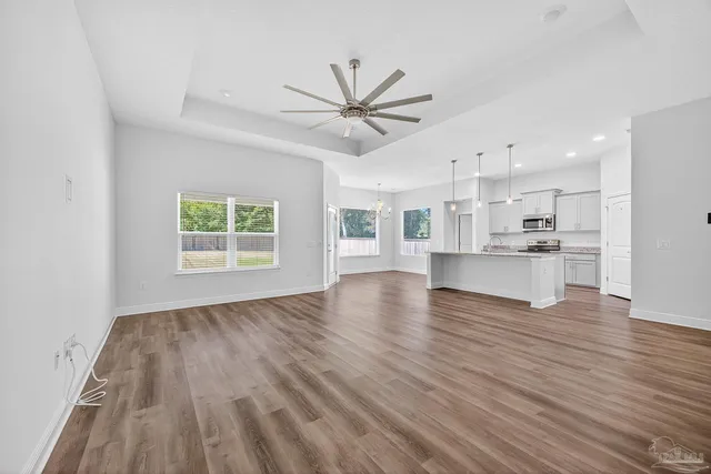 an empty room with a window and a fan