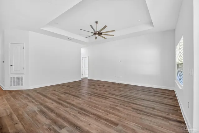 an empty room with closet and a chandelier fan