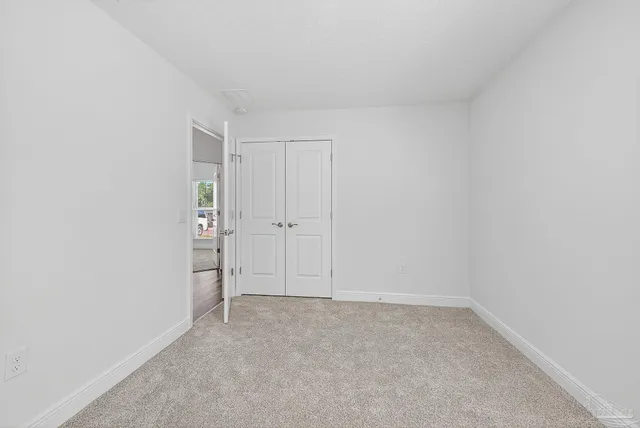 a front view of a house with a garden and patio
