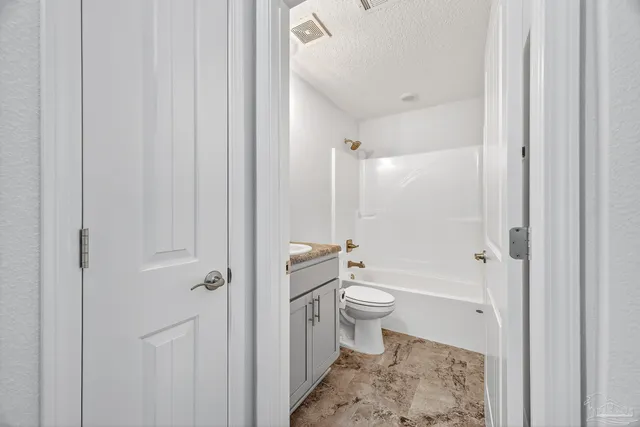 a front view of a house with a garden and patio